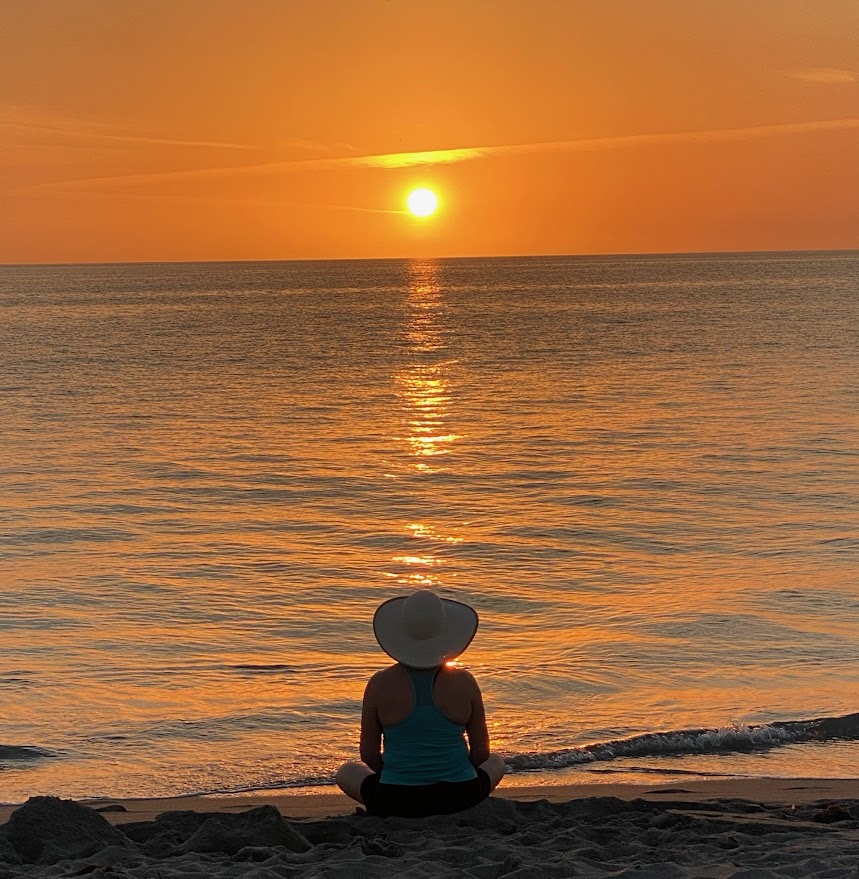 Woman sitting and watching sunset